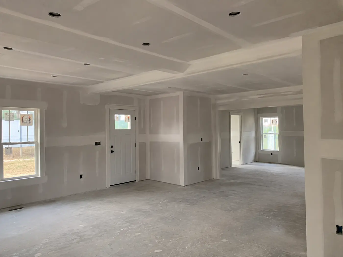Newly hung and taped drywall in an open floor plan addition in Mason, OH