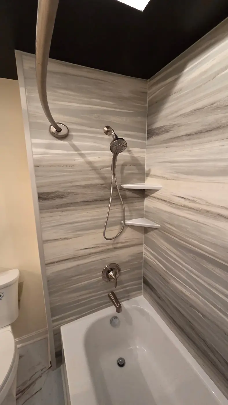 Tub and shower combo with striated gray surround and handheld sprayer in Mason, OH