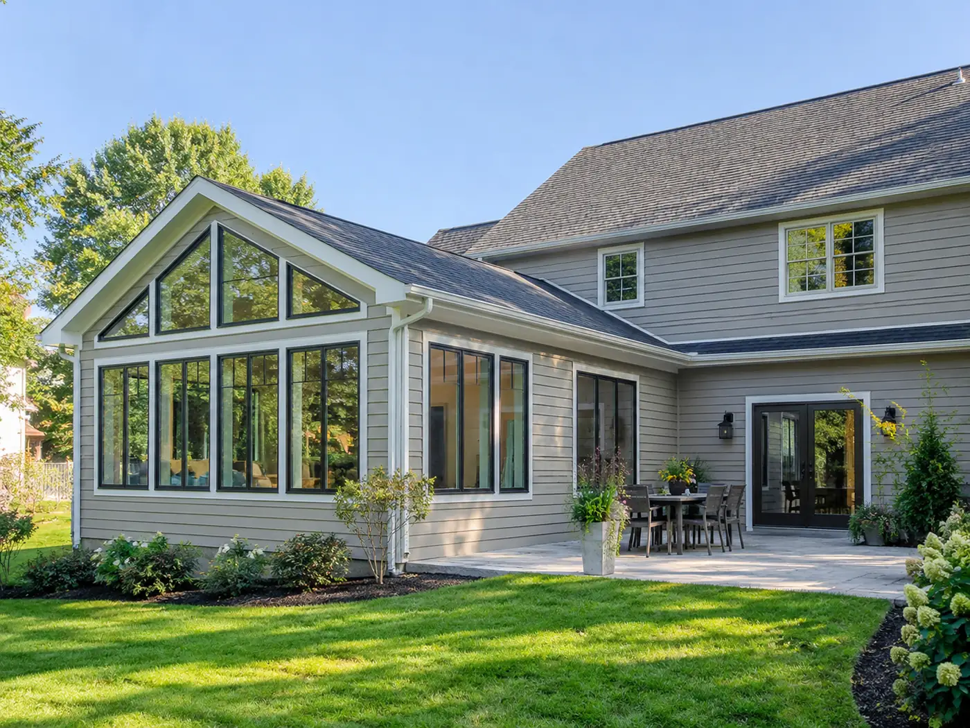 Vaulted sunroom addition with floor-to-ceiling windows off a patio in Mason, OH