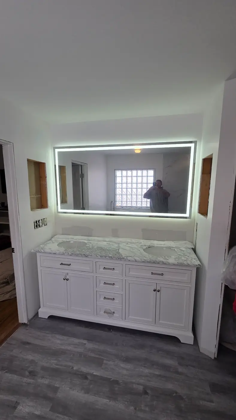 White double vanity with marble top and backlit LED mirror installed in Mason, OH