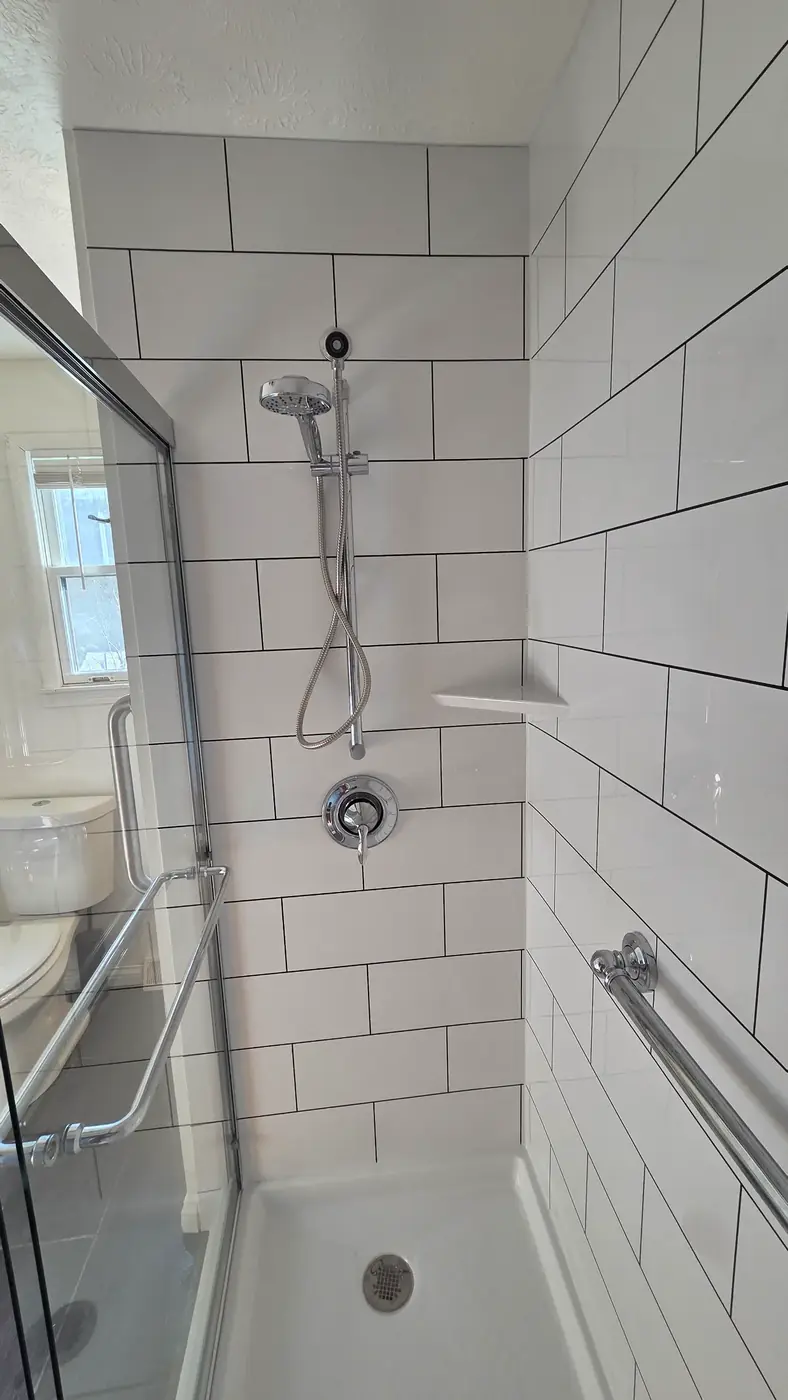 Walk-in shower with white subway tile, handheld sprayer and grab bar in Mason, OH